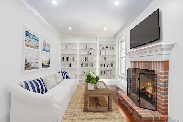 638 Allegan St, Saugatuck, MI 49453 - living room featuring a fireplace, crown molding, dark wood-type flooring, recessed lighting, and built in features