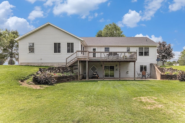 back of house featuring a lawn, a wooden deck, stairs, and a patio area