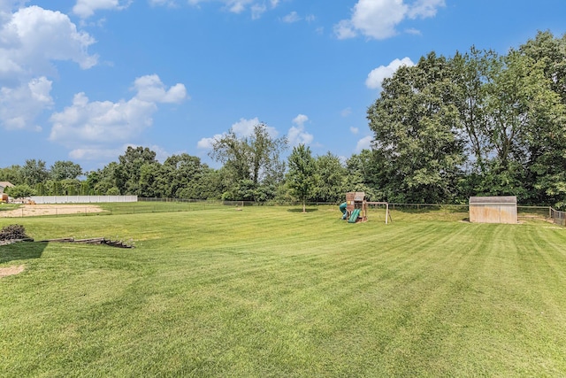 view of yard featuring fence and a playground