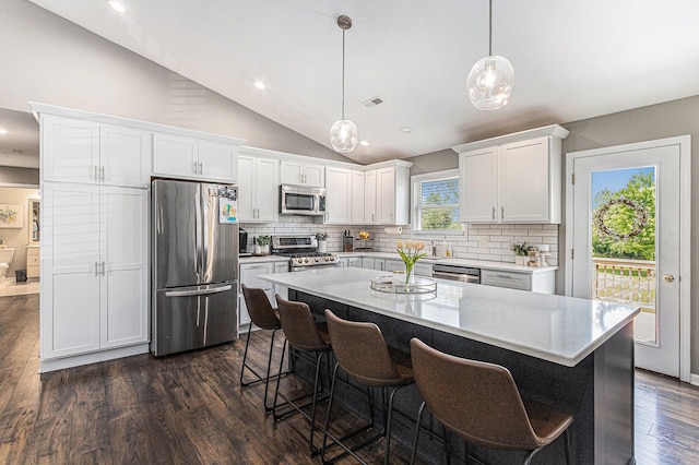 kitchen featuring visible vents, decorative backsplash, dark wood-style flooring, and appliances with stainless steel finishes