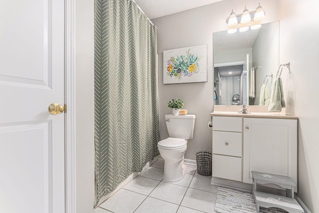 bathroom with toilet, tile patterned flooring, and vanity