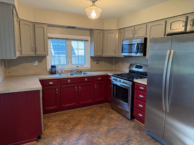 kitchen with stainless steel appliances, light countertops, dark brown cabinets, a sink, and tasteful backsplash
