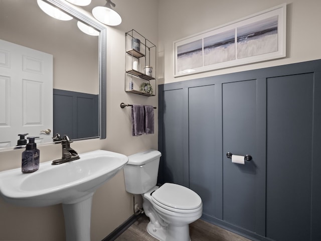 41698 Brownstone Dr, Novi, MI 48377 - half bath featuring wainscoting, a sink, a decorative wall, and toilet