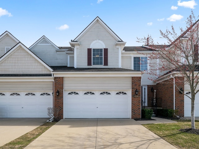 41698 Brownstone Dr, Novi, MI 48377 - view of front of house featuring brick siding, an attached garage, driveway, and roof with shingles