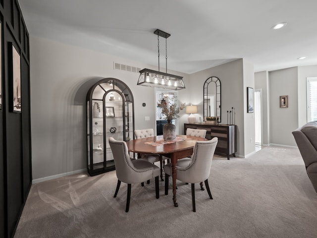 41698 Brownstone Dr, Novi, MI 48377 - dining area featuring arched walkways, baseboards, visible vents, recessed lighting, and light colored carpet