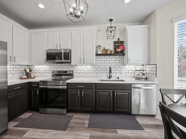 41698 Brownstone Dr, Novi, MI 48377 - kitchen with white cabinets, stainless steel appliances, light countertops, and a sink