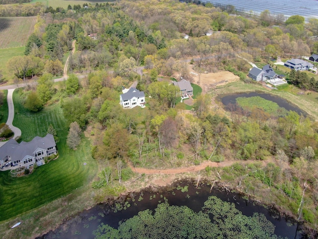aerial view with a wooded view and a water view
