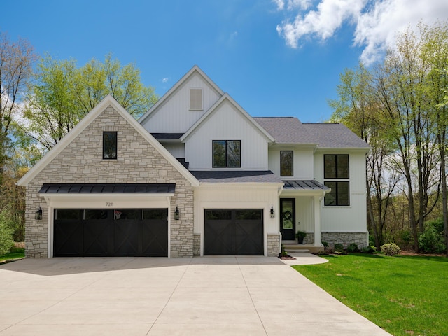 modern farmhouse featuring stone siding, driveway, a front yard, a shingled roof, and a standing seam roof