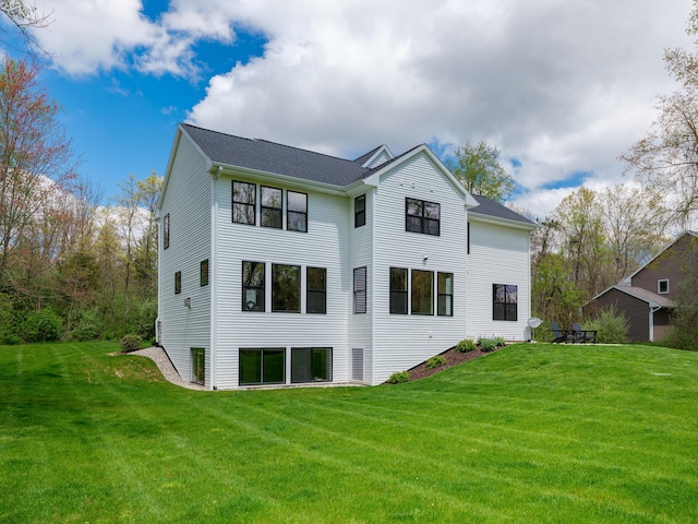 back of property with a lawn