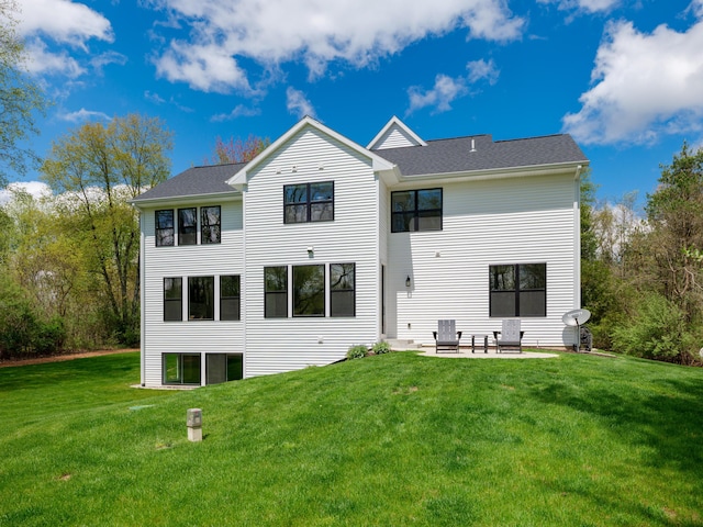 back of property with a yard and a patio
