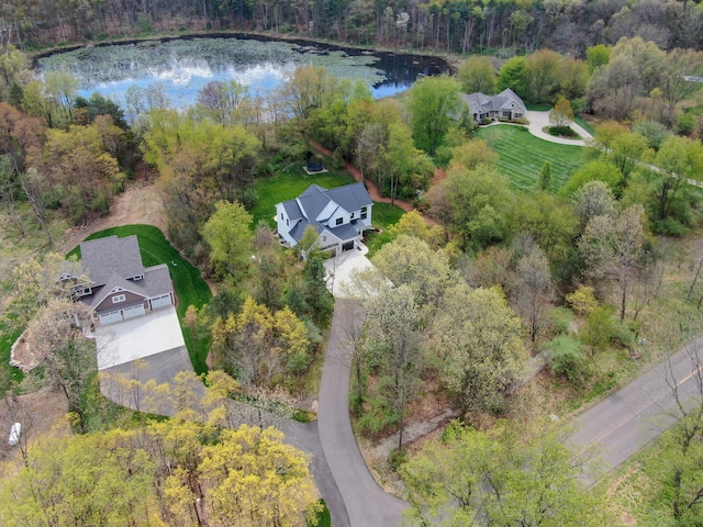 drone / aerial view featuring a water view and a view of trees