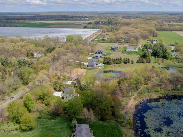 birds eye view of property with a water view and a rural view
