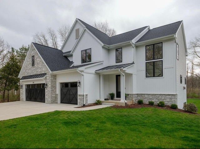 7211 W R Ave, Kalamazoo, MI 49009 - modern farmhouse featuring stone siding, a standing seam roof, a front yard, concrete driveway, and a metal roof