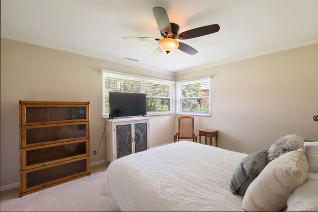 bedroom with crown molding, carpet flooring, visible vents, baseboards, and a ceiling fan