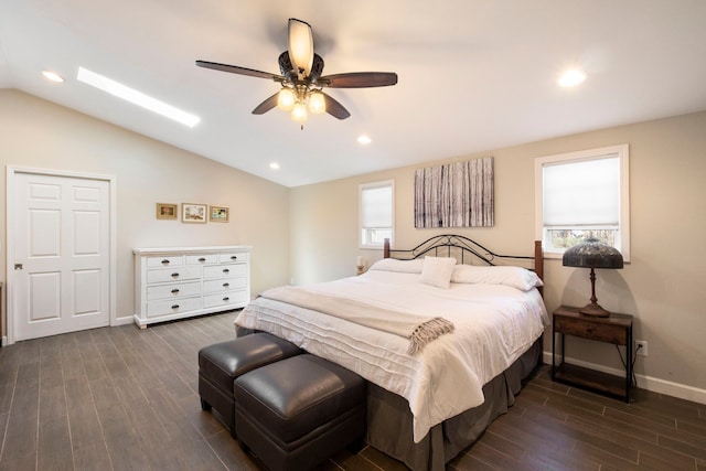 bedroom with ceiling fan, baseboards, lofted ceiling, and dark wood finished floors