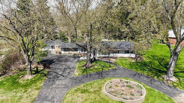 exterior space featuring driveway and a lawn