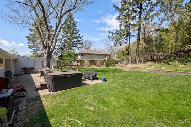 view of yard with cooling unit, a patio, and a hot tub