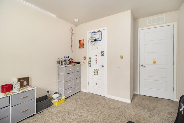 carpeted bedroom featuring baseboards and visible vents