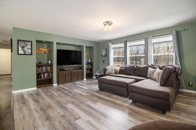 living area featuring wood finished floors and baseboards