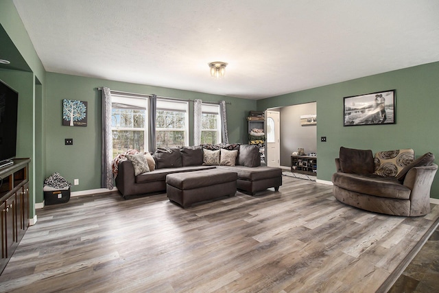living room featuring baseboards and wood finished floors