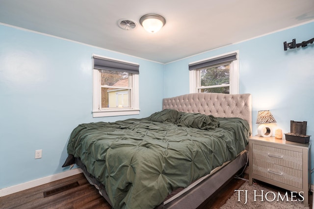 bedroom with baseboards, visible vents, and multiple windows