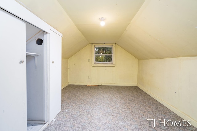 additional living space featuring vaulted ceiling