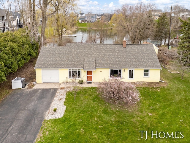 view of front of home with a chimney, a residential view, a shingled roof, and a garage