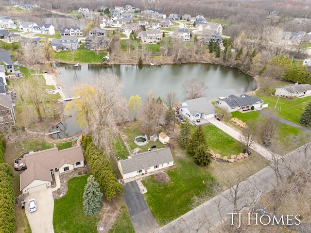 drone / aerial view featuring a water view and a residential view