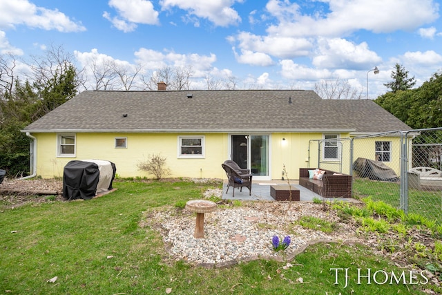 rear view of property featuring fence, a yard, a patio, and a shingled roof