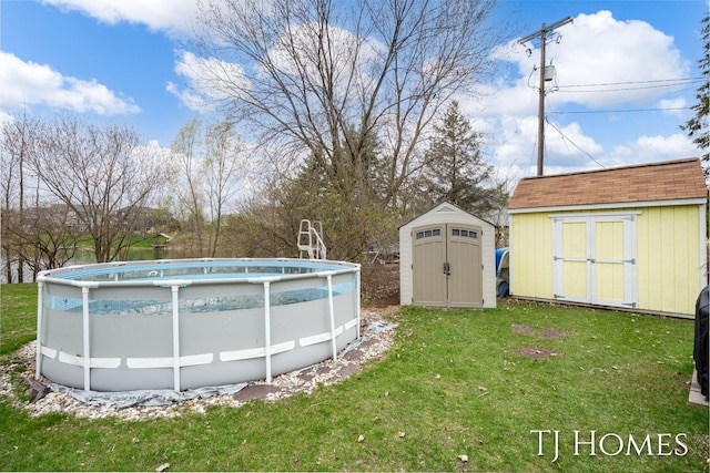 pool with an outbuilding, a yard, and a storage shed