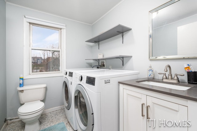 laundry room featuring a sink, baseboards, ornamental molding, laundry area, and independent washer and dryer
