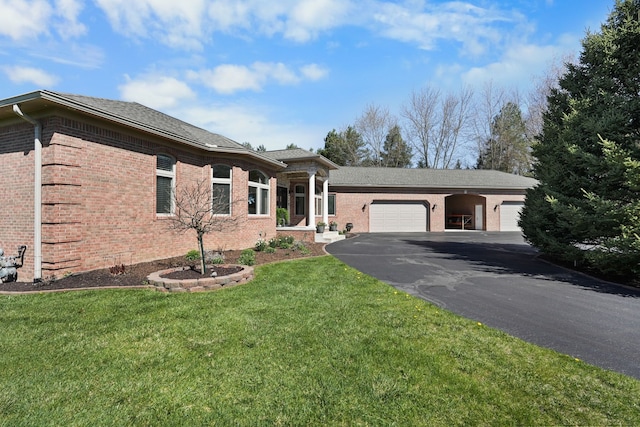 70799 Fisher Rd, Bruce, MI 48065 - view of front of home featuring an attached garage, aphalt driveway, a front lawn, and brick siding