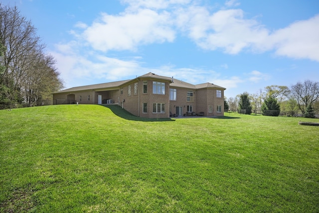 70799 Fisher Rd, Bruce, MI 48065 - back of house featuring a yard and brick siding