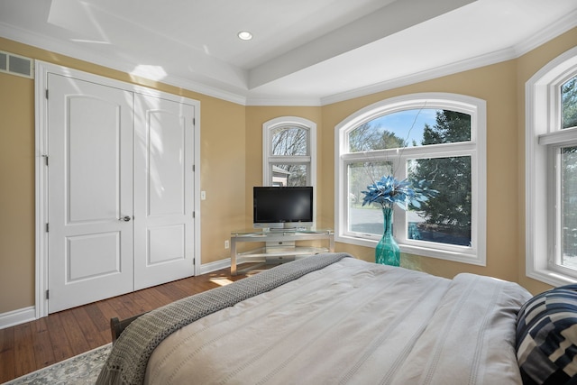 70799 Fisher Rd, Bruce, MI 48065 - bedroom featuring hardwood / wood-style floors, baseboards, multiple windows, and a tray ceiling