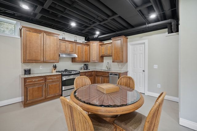 70799 Fisher Rd, Bruce, MI 48065 - kitchen featuring brown cabinetry, stainless steel appliances, under cabinet range hood, a sink, and baseboards
