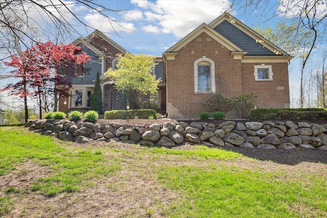 8504 Riverwalk Dr, Fenton, MI 48430 - view of home's exterior featuring brick siding and a yard