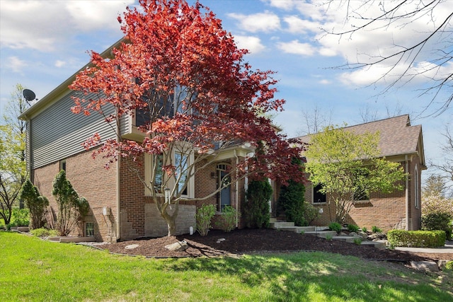 8504 Riverwalk Dr, Fenton, MI 48430 - view of side of property featuring brick siding and a yard