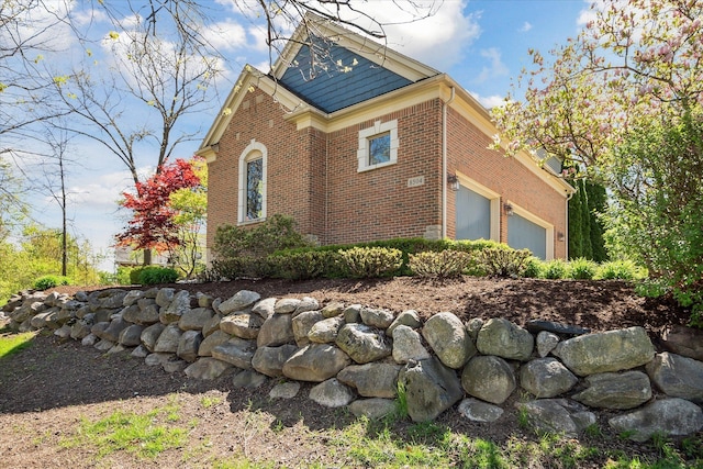 8504 Riverwalk Dr, Fenton, MI 48430 - view of side of property with brick siding and an attached garage