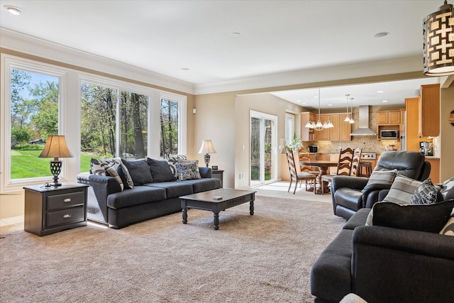 8504 Riverwalk Dr, Fenton, MI 48430 - living area featuring light carpet, a chandelier, and crown molding