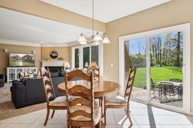 8504 Riverwalk Dr, Fenton, MI 48430 - dining area with light tile patterned floors, healthy amount of natural light, a chandelier, and ornamental molding