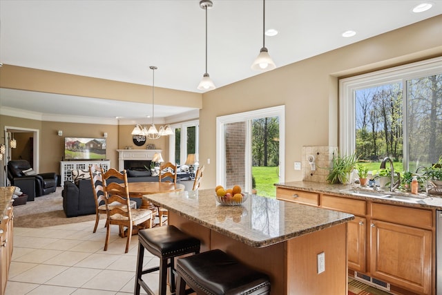 8504 Riverwalk Dr, Fenton, MI 48430 - kitchen featuring a sink, open floor plan, a center island, light stone countertops, and recessed lighting