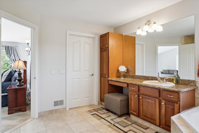 8504 Riverwalk Dr, Fenton, MI 48430 - bathroom with vanity, tile patterned floors, and a relaxing tiled tub