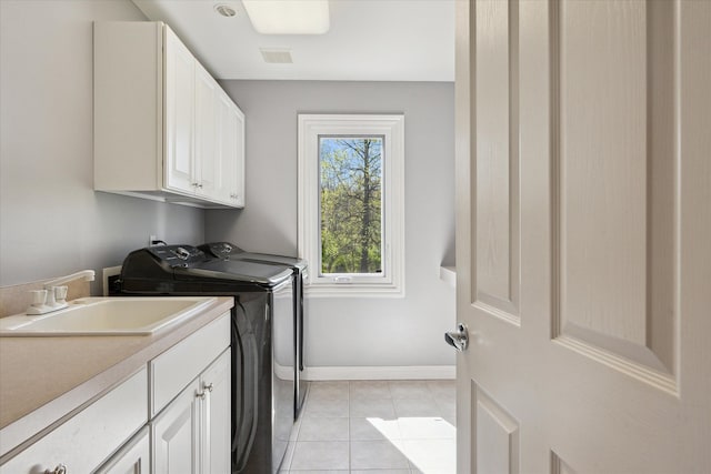 8504 Riverwalk Dr, Fenton, MI 48430 - washroom with washer and dryer, cabinet space, light tile patterned floors, and baseboards