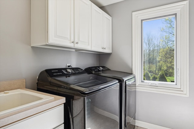 8504 Riverwalk Dr, Fenton, MI 48430 - laundry area featuring cabinet space, washer and dryer, and baseboards