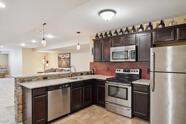 8504 Riverwalk Dr, Fenton, MI 48430 - kitchen featuring stainless steel appliances, a sink, open floor plan, a peninsula, and recessed lighting