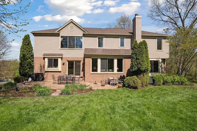 8504 Riverwalk Dr, Fenton, MI 48430 - back of property featuring brick siding, a chimney, a lawn, a patio area, and a shingled roof