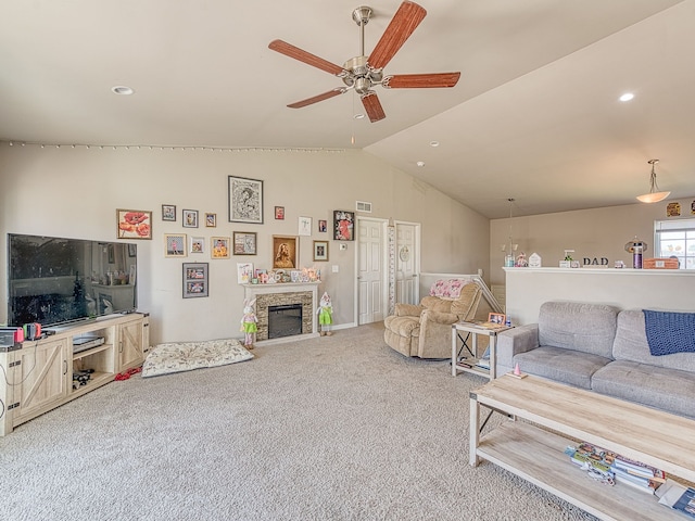 159 St Clair Cir, Brooklyn, MI 49230 - living area featuring vaulted ceiling, a stone fireplace, visible vents, carpet flooring, and ceiling fan