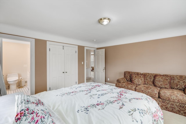 bedroom featuring a closet and ensuite bath