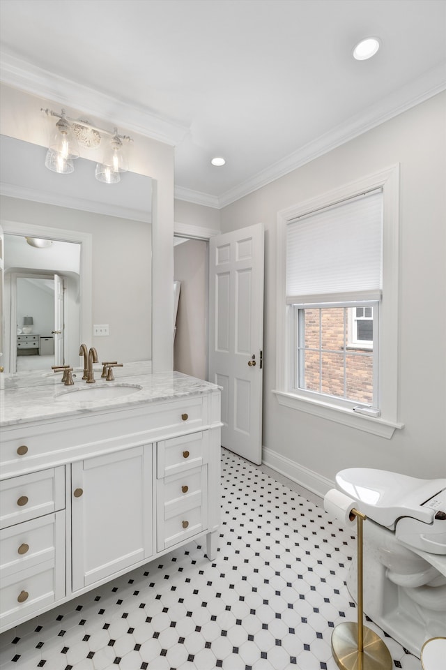 bathroom featuring baseboards, crown molding, vanity, and recessed lighting