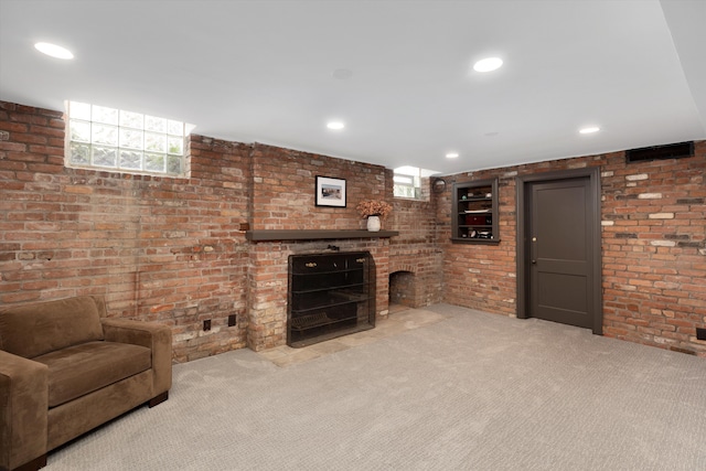 carpeted living room with a fireplace, healthy amount of natural light, brick wall, and recessed lighting
